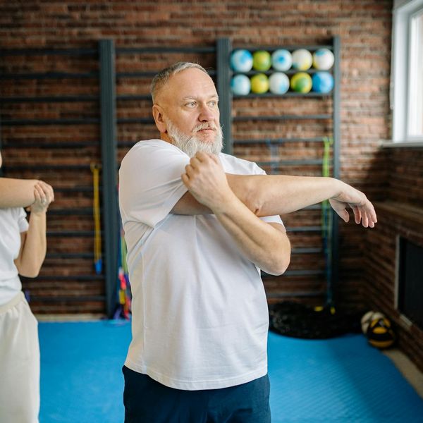 Person balancing gracefully during a complex exercise routine.