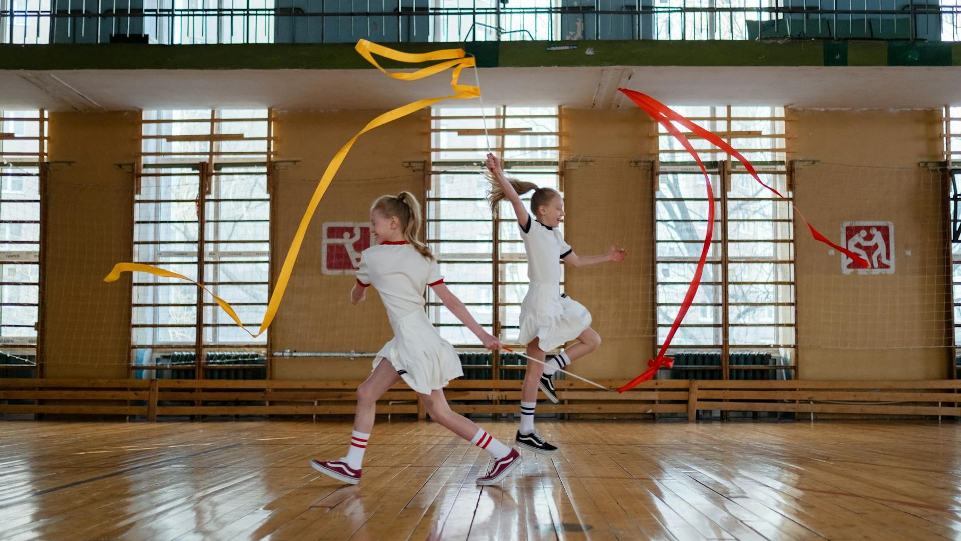 Person performing active rhythmic movements in a modern gym space.